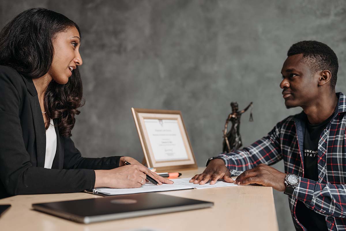 Female Lawyer Discussing Taxes with Young Man