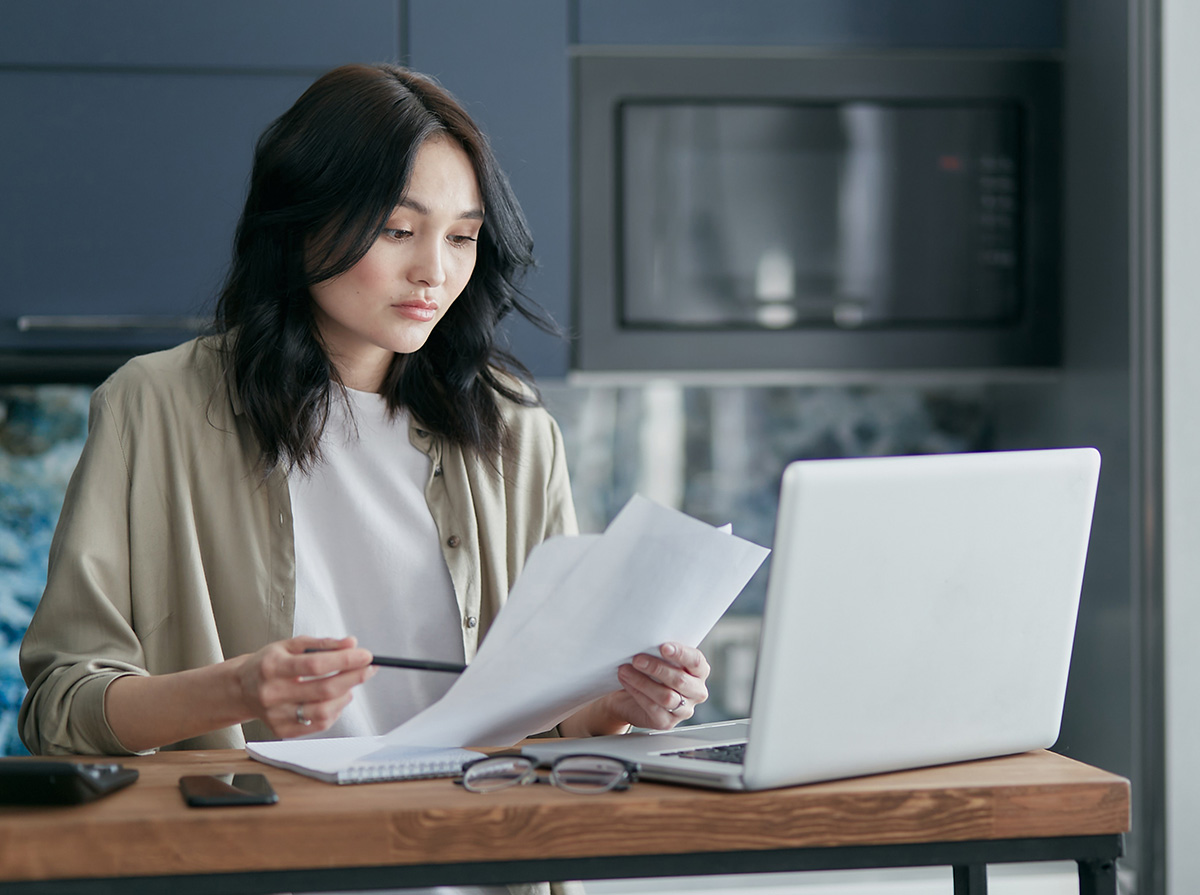 Woman Reading Paperwork on IRS Fresh Start Program