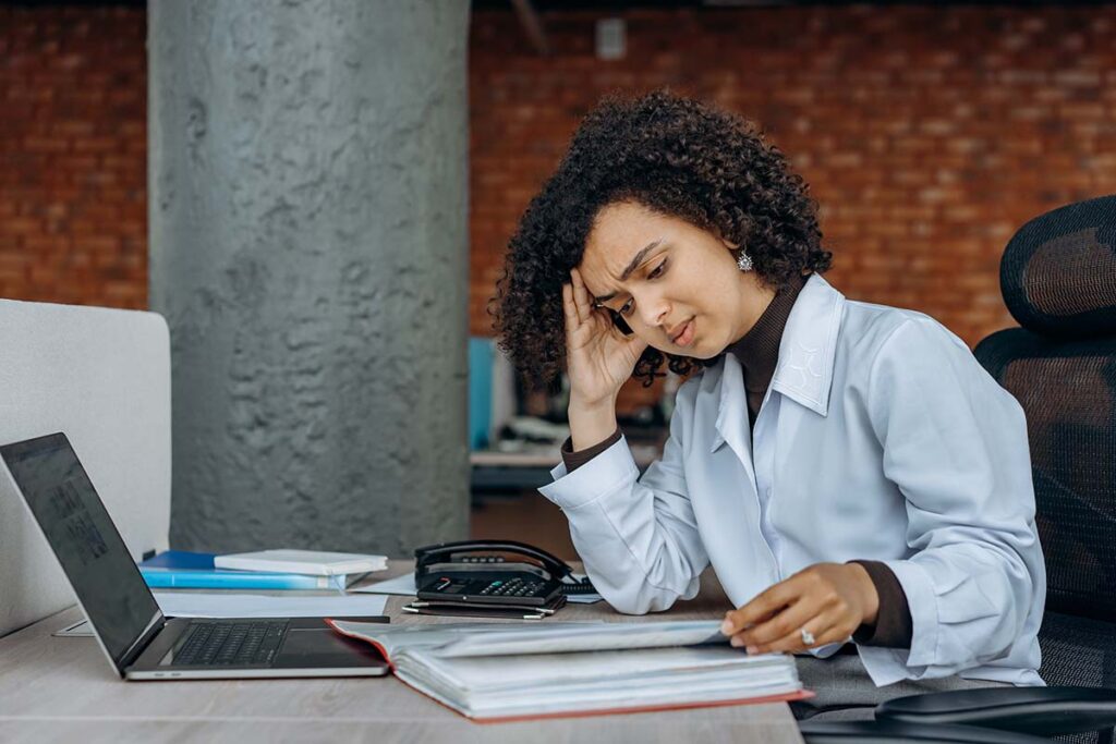 Lady Looking over Tax Paperwork Confused