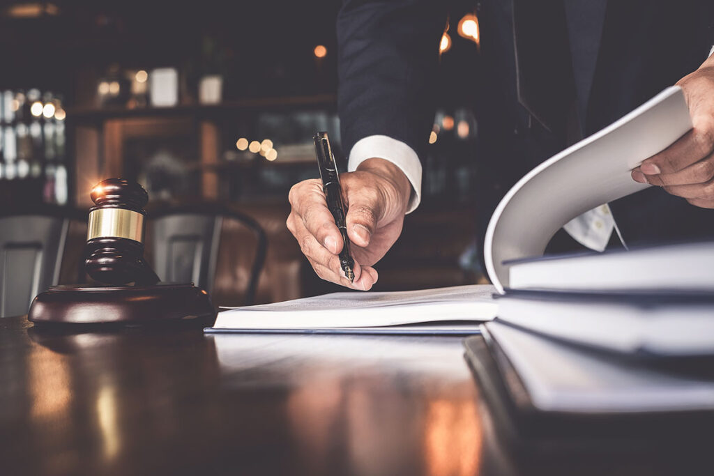 Man Signing Paperwork in Lawyer Office