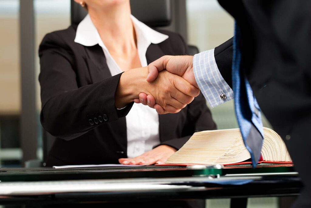 Man and Woman in Suits Shaking Hands