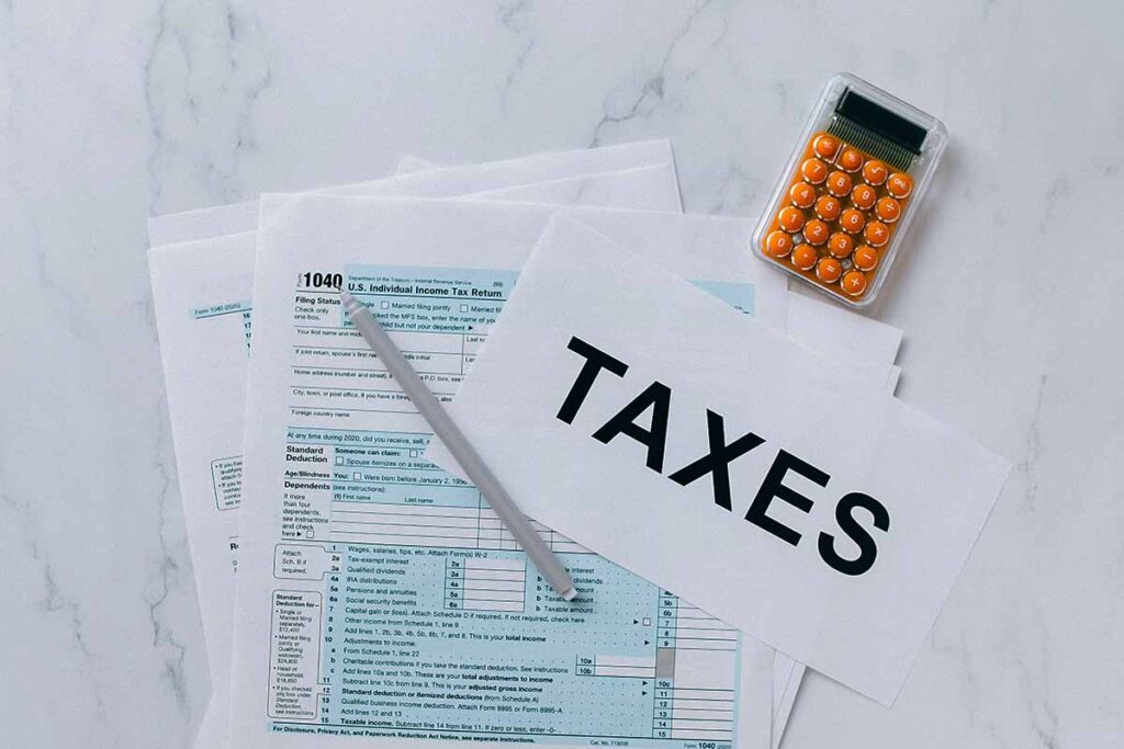 Tax Paperwork on Desk with Calculator