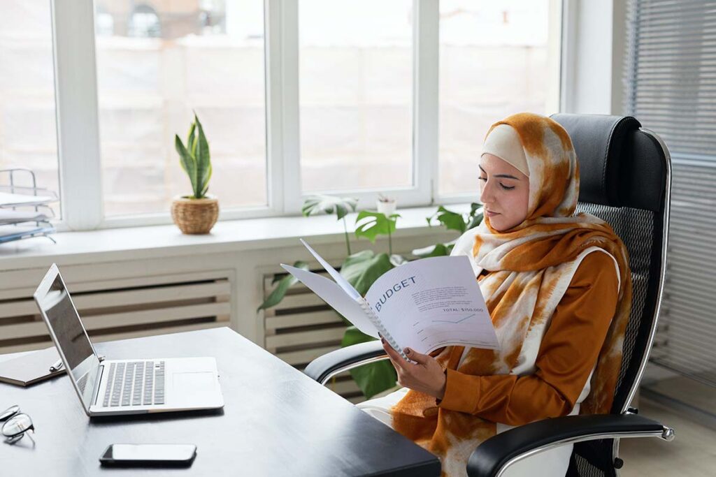 Woman in Hijab Reading Over IRS Fresh Start Program