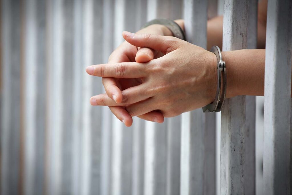 handcuffs behind bars