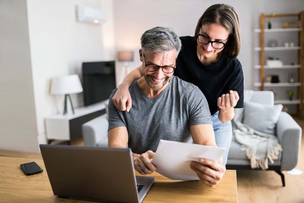 Happy couple at computer